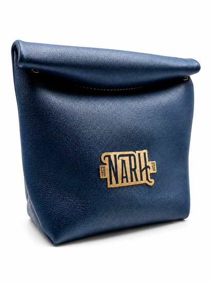 A navy blue textured leather pouch with a roll-top closure and a gold-tone metal &